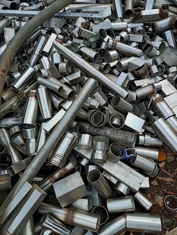 A large heap of assorted metal pipes and tubes in Indore, showcasing industrial materials.
