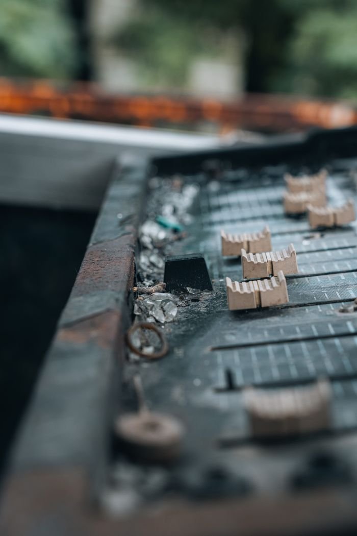 our-story Detailed shot of decaying electronic equipment with rust and debris, highlighting technology's transient nature.