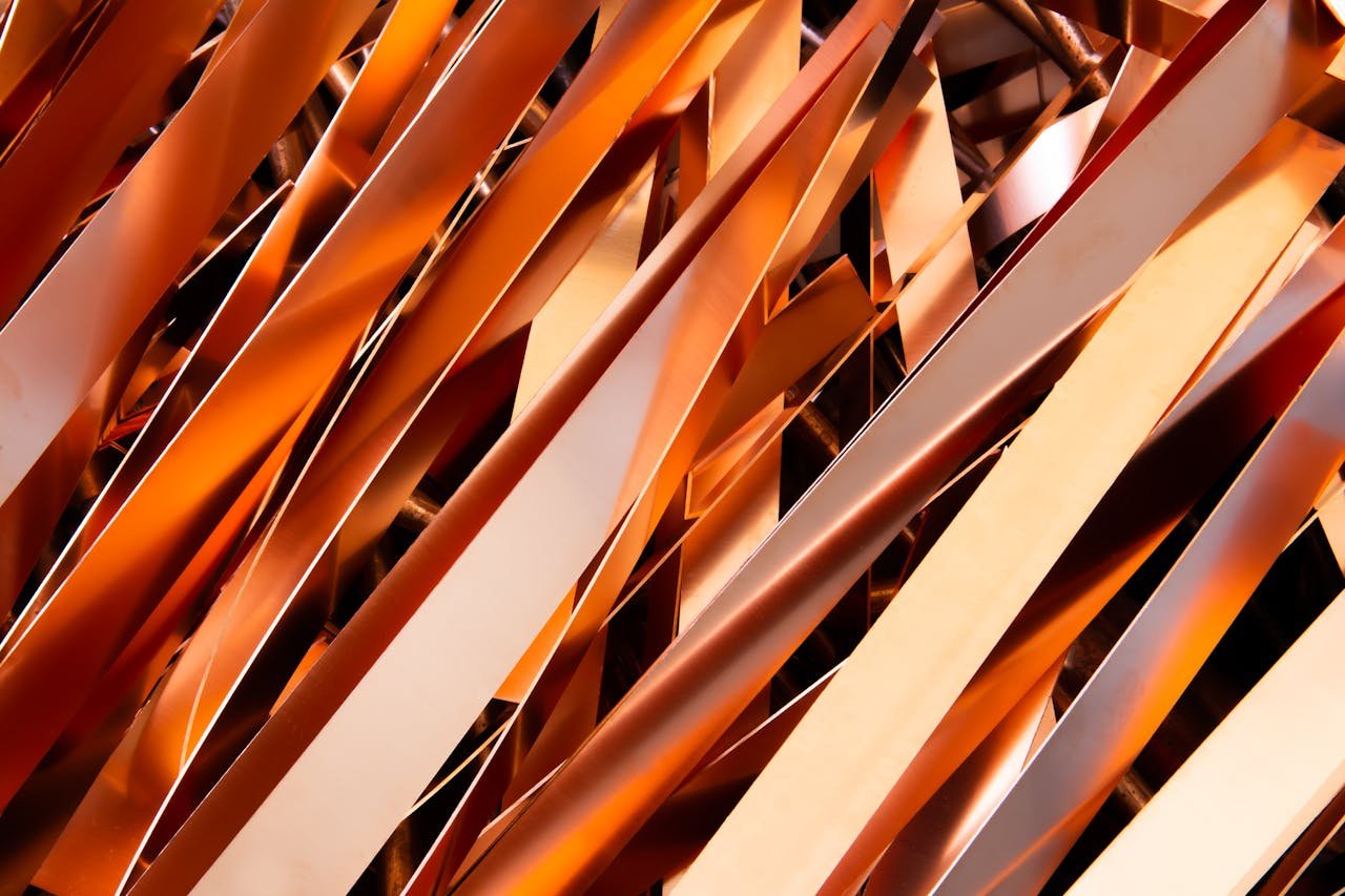 Services-03 Close-up of intertwined metallic strips showcasing industrial recycling processes.